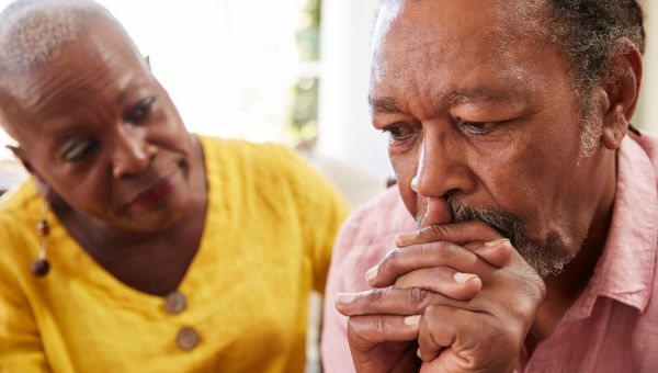 mature couple, conversation, worried, husband, wife, clasped hands