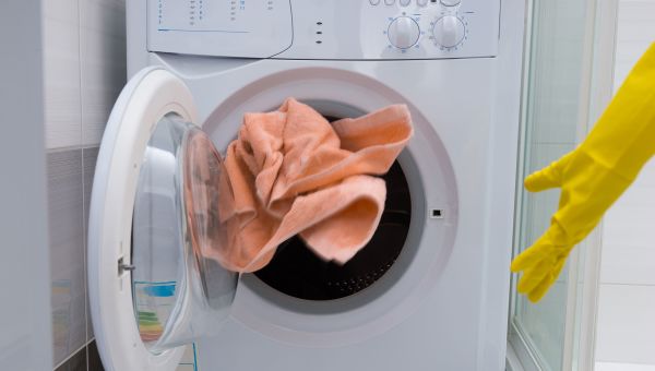 towel, dryer, yellow glove, gloved hand throwing a towel