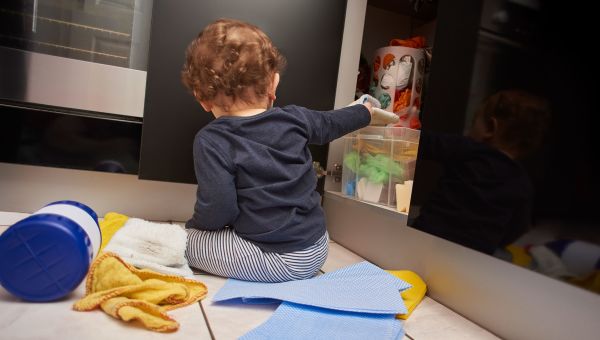toddler grabbing items in kitchen cabinet, kitchen dangers for children