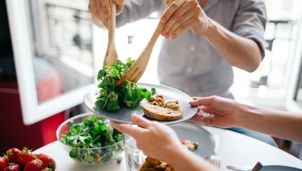 woman serving salad, fresh veggies, salad, healthy eating