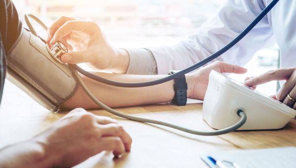 doctor checking blood pressure