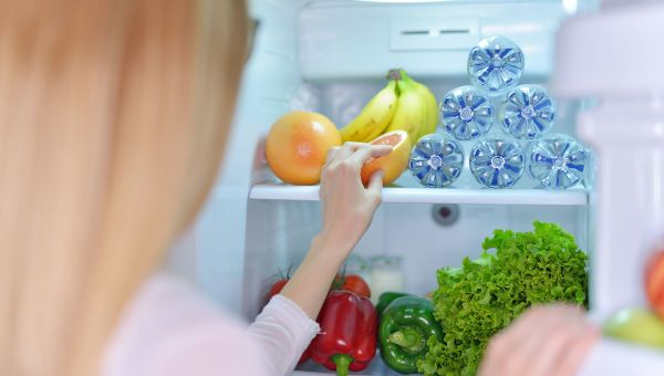 woman looking in refrigerator