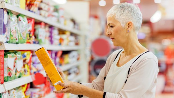 Senior woman reading nutrition labels on food