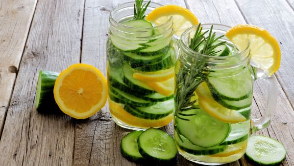 Mason jars filled with clean water, cucumber and lemon slices