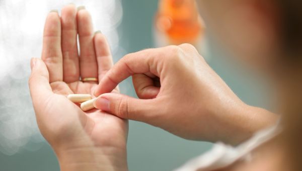 Woman taking vitamin supplements