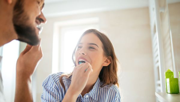 couple brushing teeth