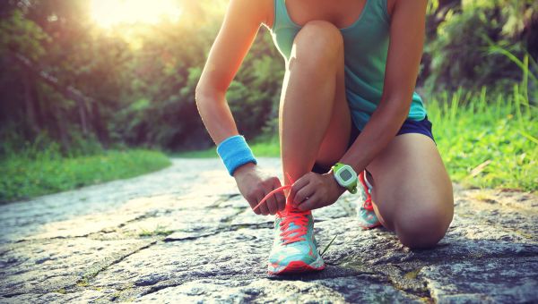 young woman tying her shoelaces