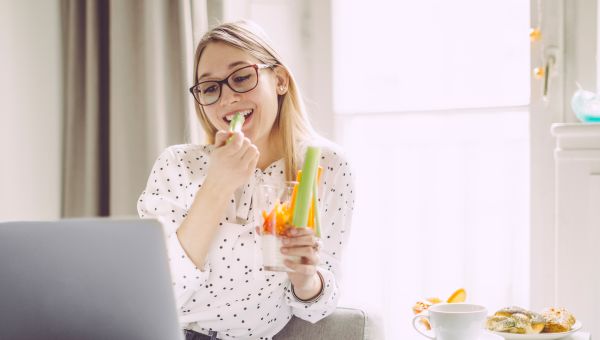 young woman eating celery