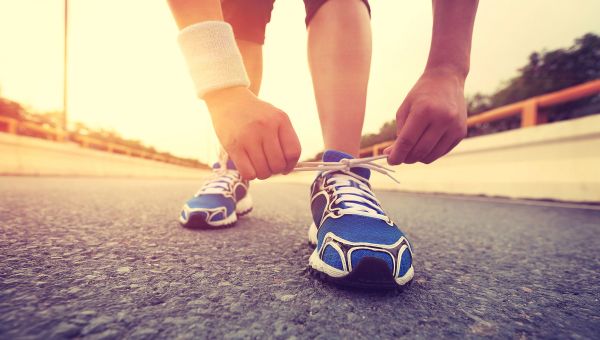 tying sneakers on outdoor track