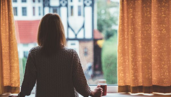 young woman looking out the window