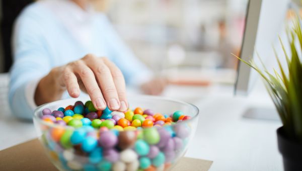 a hand reaching for the candy