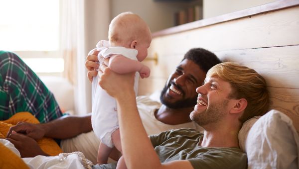 couple with baby in bed