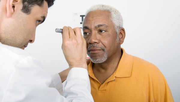 Older person gets their eyes checked.