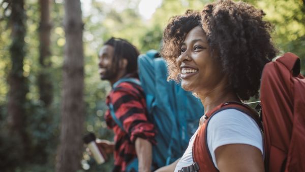 happy Black couple going on a hike, breathing fresh air