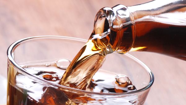 cola soda being poured into a glass