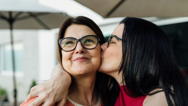 daughter kissing mom on cheek