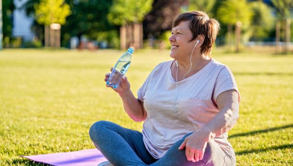 middle-aged woman after exercising in park