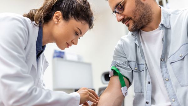 a man getting a blood draw from a nurse