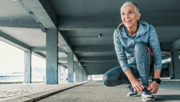 A person lacing up their shoes for a much needed walk. 