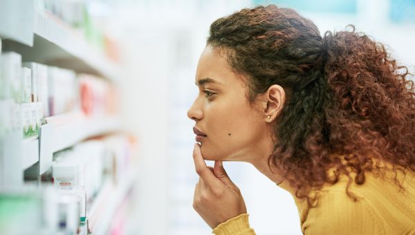 young woman looking through yeast infection medication