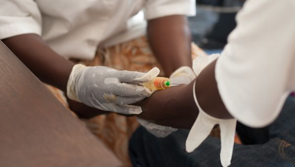 nurse in a rural hospital draws the blood of a man to test for ebola