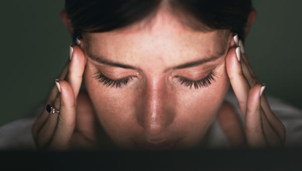 closeup of a woman's holding her temples