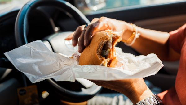 woman eating in car while driving