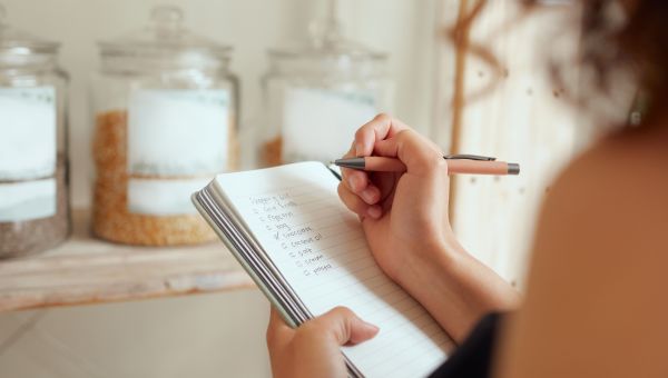 woman writing grocery list