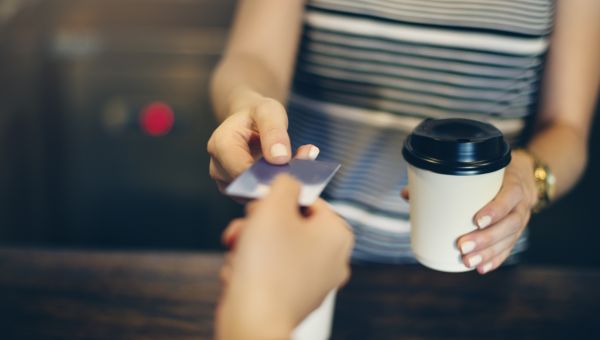 woman paying for coffee with card