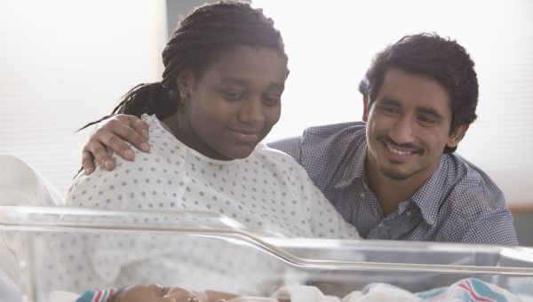 two parents, hospital room, newborn in hospital bassinet