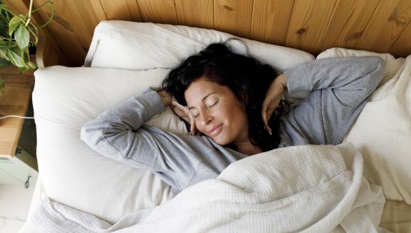 woman waking up in bed happy