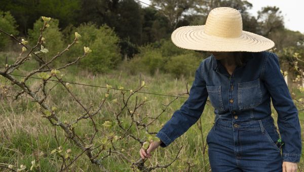 someone outside wearing broad-brimmed hat, long sleeves and long pants