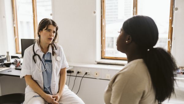 female doctor talking to young patient