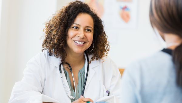 women doctor and patient sitting at desk