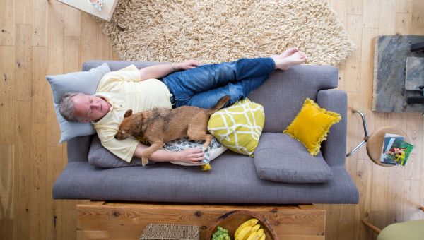 Man laying on couch with dog, man sleeping on sofa