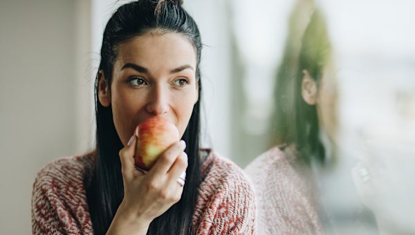 someone biting into an apple