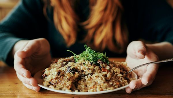 woman serving plate of rice