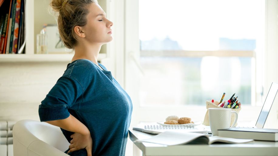 back pain, woman at a desk, stretching