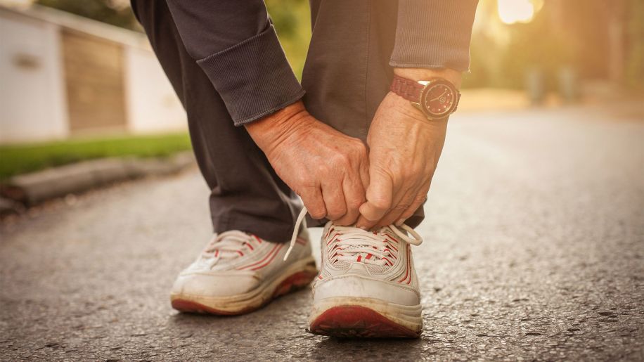 Man tying his sneakers.