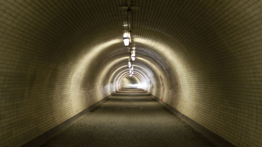 View down a long semi-lit tunnel.