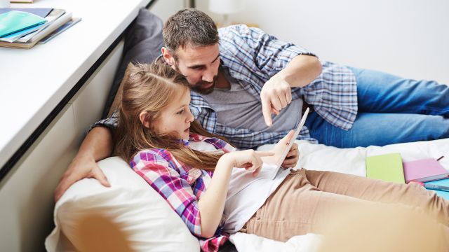 father and daughter going over homework together