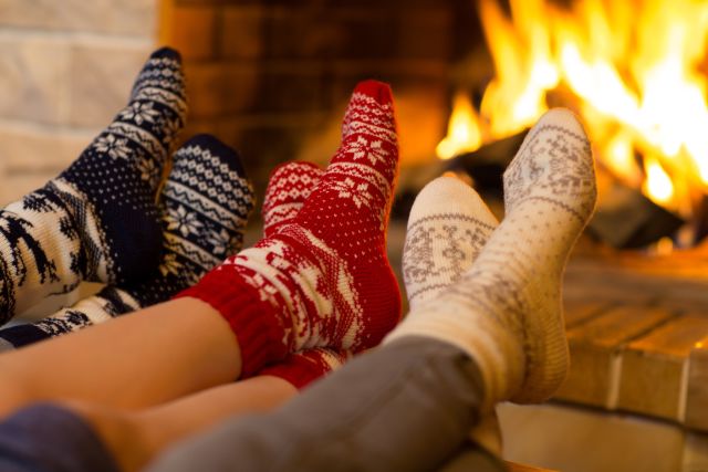 People in socks near fireplace