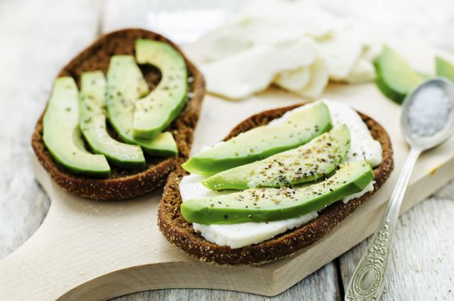 sandwich of rye bread with avocado and goat cheese. tinting. selective focus