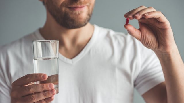 A man takes his medication for benign prostatic hyperplasia; treatments may also include natural home remedies and surgery.