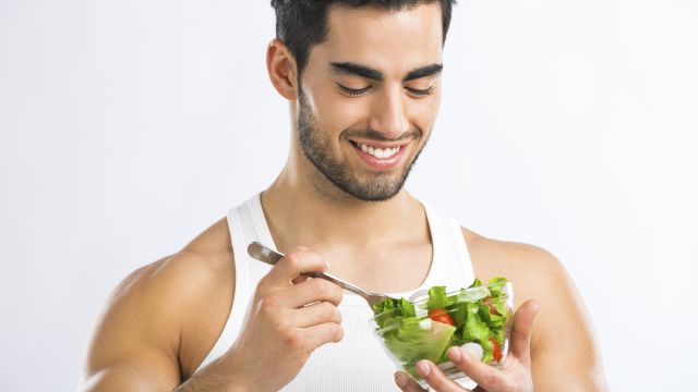 A man eats a salad. He knows one possible cause of prostate cancer and enlarged prostate is a diet heavy in meat and dairy.  