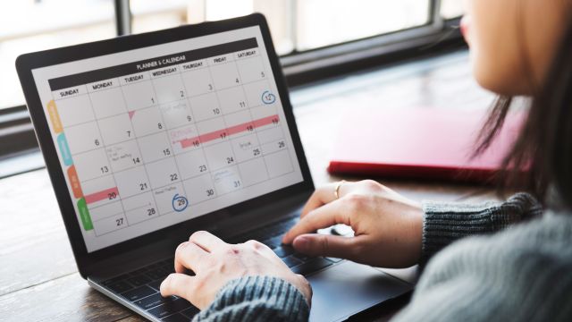 A young woman in multiple myeloma remission adding a doctor's appointment to her calendar.