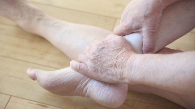 senior woman rubbing her ankle, ankle pain, pain, hereditary angioedema