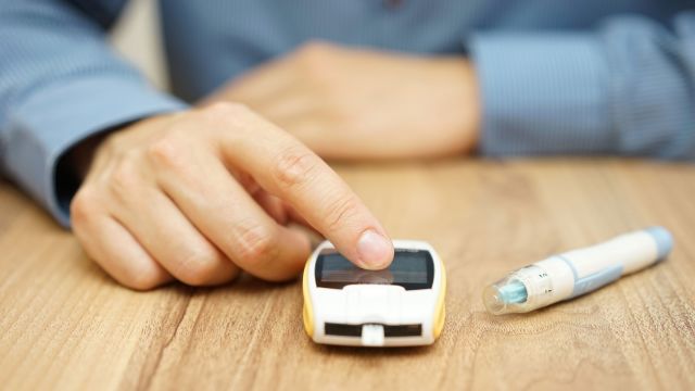 man testing glucose level, diabetic, diabetes treatment