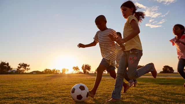 kids playing outside, soccer, soccer ball, sunset, blue sky