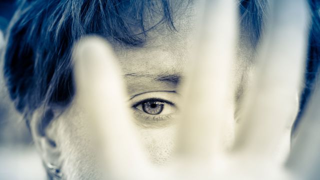 woman saying no, woman covering face with hand